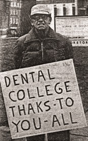 man holding sign thanking dental school