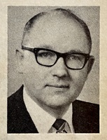 headshot of a middle-aged white male with glasses