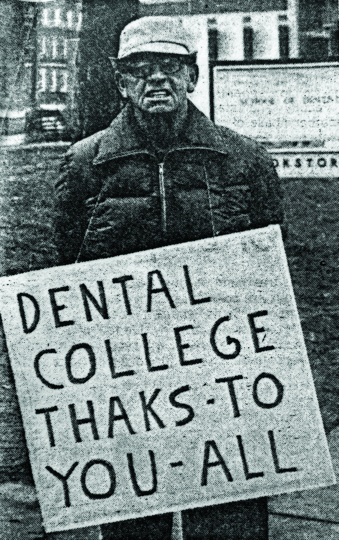 man holding sign thanking dental school